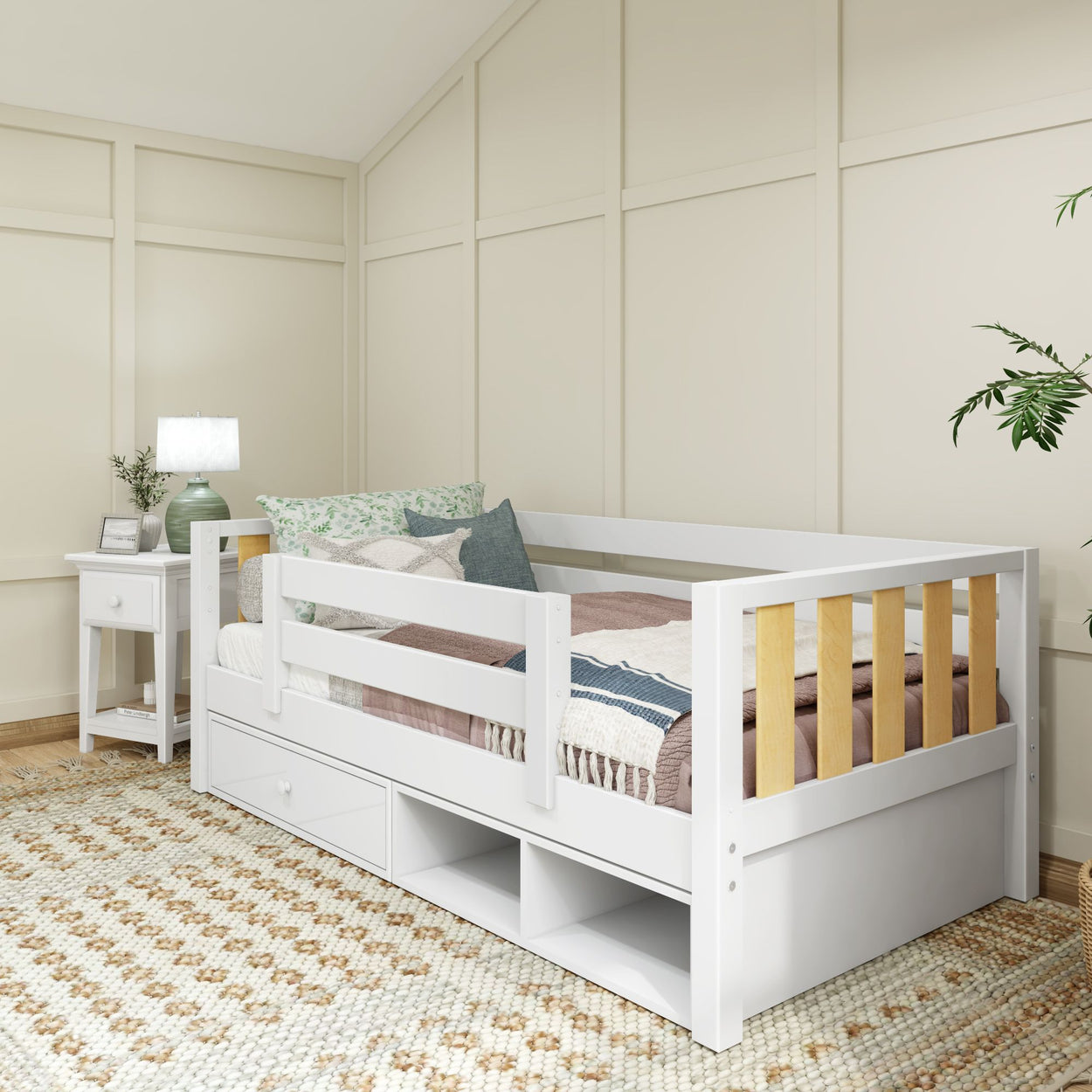 Cozy bedroom with white daybed, stylish bedding, and elegant decor featuring a bedside table and lamp.