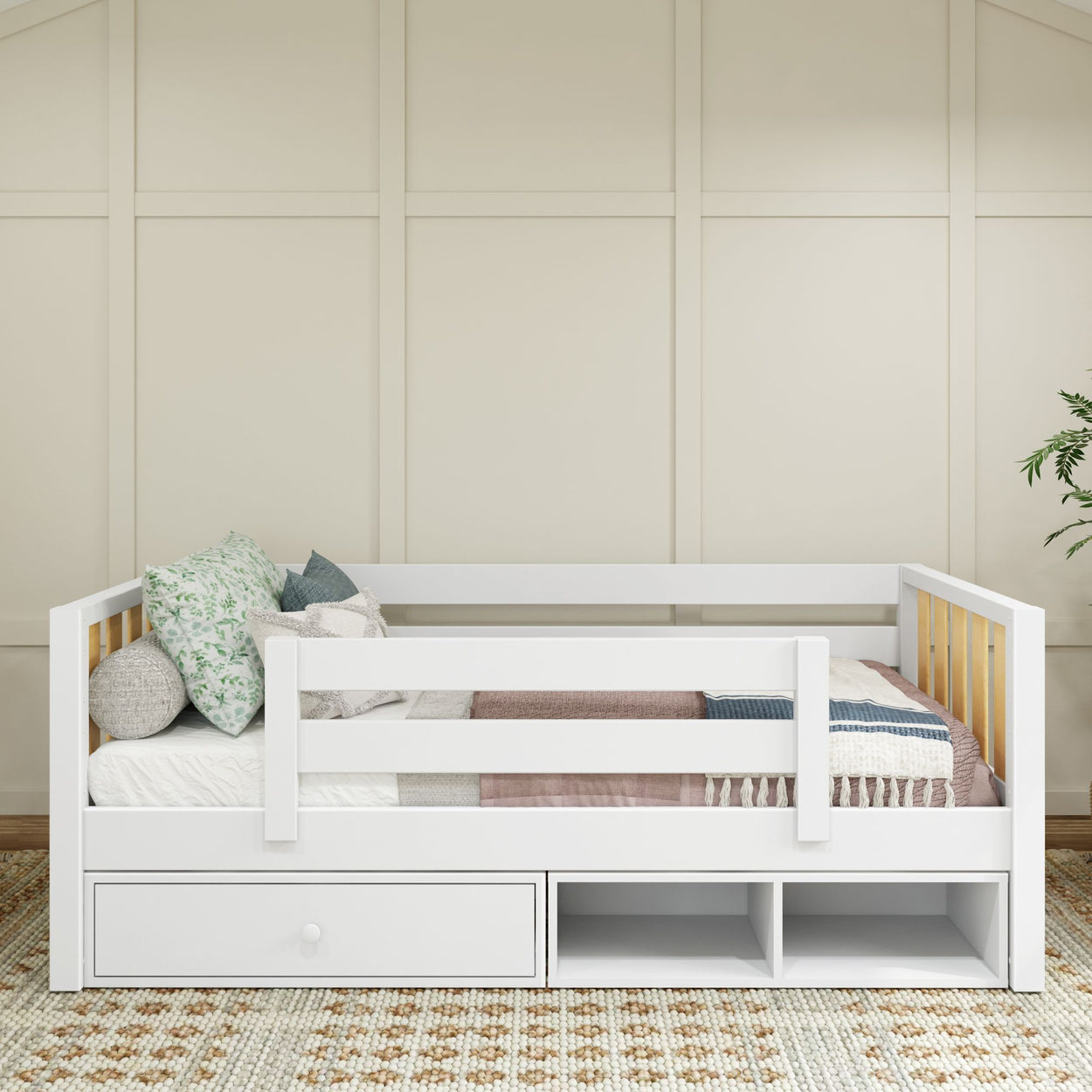 Stylish white kids daybed with storage and decorative pillows in a modern bedroom setting.