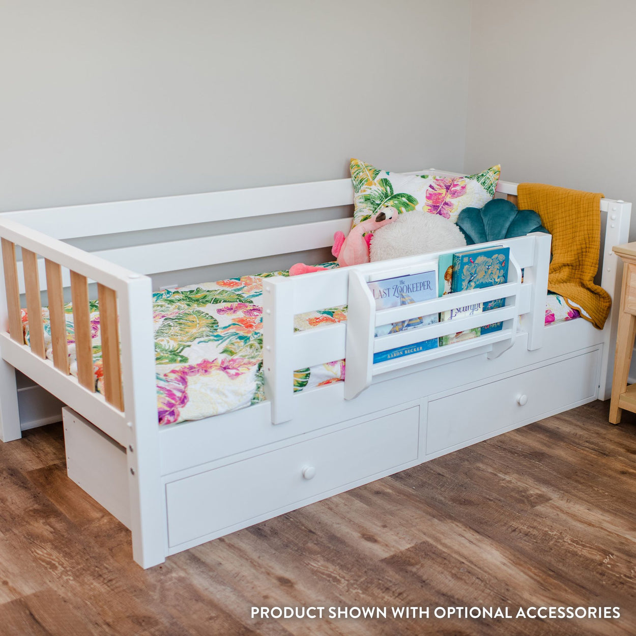 White daybed with storage drawers and floral bedding in a cozy room.