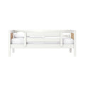 White wooden twin bunk bed with guardrail and wood slat accents, white bedding and pillows