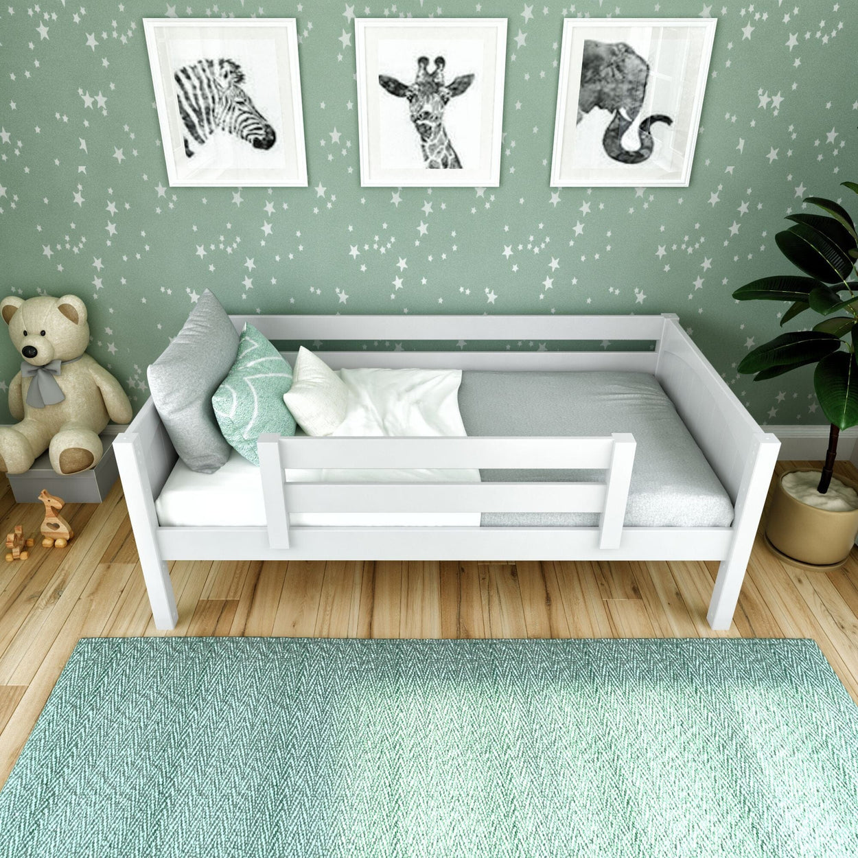 Cozy kids nursery with white toddler bed, mint green star wallpaper, framed animal prints, teddy bear and textured rug