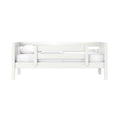White wooden toddler daybed with safety rails, white mattress and pillow, modern minimalist children's bedroom furniture