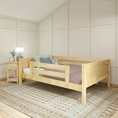 Cozy bedroom with light wood daybed and nightstand, featuring a patterned rug and soft lighting.